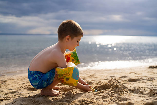 istock Little boy playing on the beach 2204485465