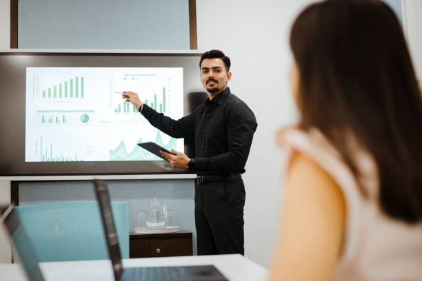 istock Manager giving a projection screen presentation to office staff 2204486925