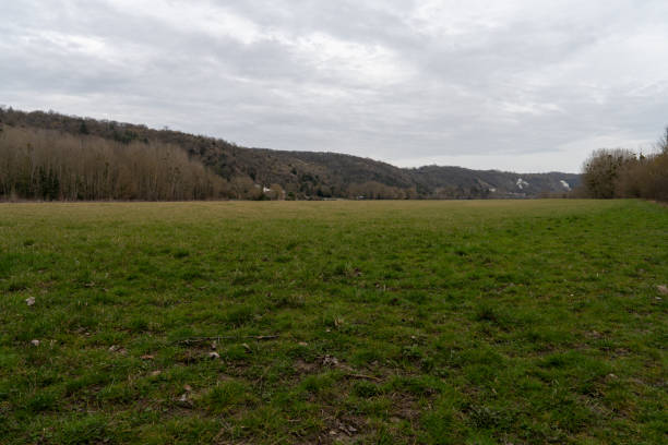 istock Expansive green fields stretch beneath a moody sky in La Roche-Guyon, inviting exploration and reflection in the Pontoise district of France 2204486995