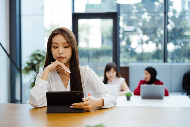 istock Asian businesswoman working with digital tablet in office 2204487741