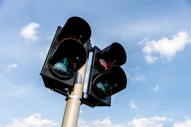 istock Pedestrian crossing traffic lights at an intersection against blue sky 2204488290