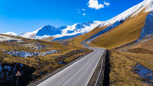 istock Aerial view  on the road surrounded by winter Landscape view 2204489097