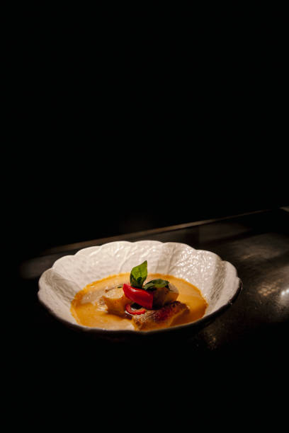 Poznan, Poland - May 6, 2014: Vegetable soup with crisp on the white plate, top view