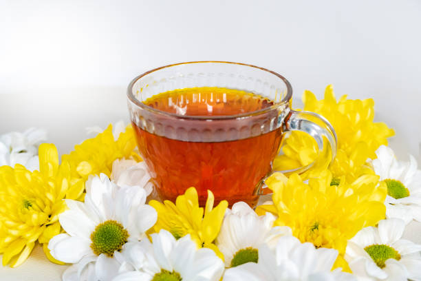 Chamomile tea with chamomile flowers on a white background