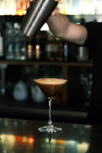 istock Bartender preparing an espresso martini cocktail at a stylish bar, Classic coffee-infused drink served in a martini glass, Professional mixology and nightlife atmosphere 2204490267
