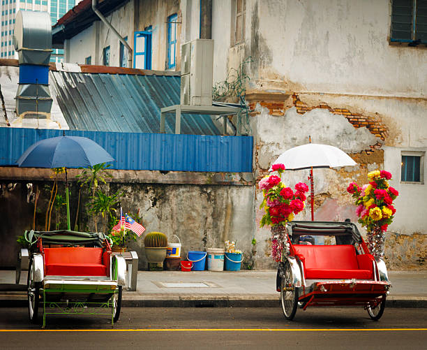 Two decorated bicycle rickshaw waiting tourists to visit Georgetown. Malaysia, beautiful colors.
