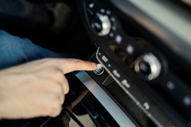 istock Cropped picture of man's finger pressing start button in a car. 2204491185