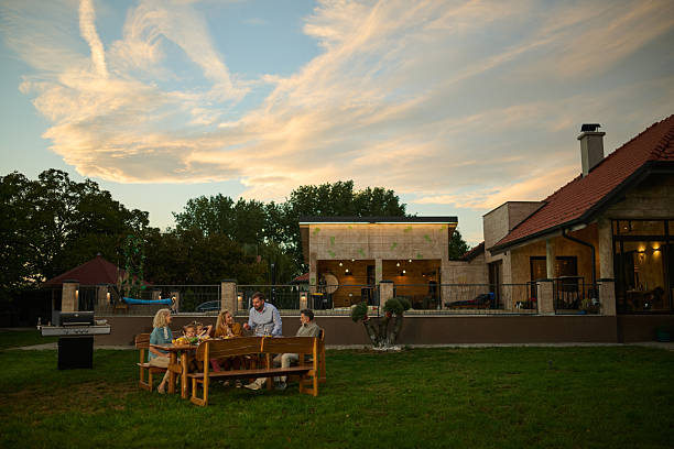 istock Family enjoying backyard barbecue dinner party at sunset 2204491637