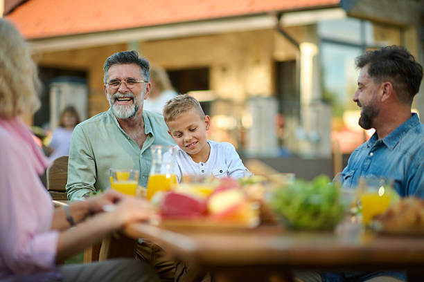 istock Happy multi generation family having lunch together on a sunny day 2204491697