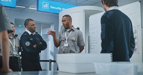 istock TSA Officer Conducts Planning Session, Uses Whiteboard, Provides Instructions to Team of Workers 2204493158