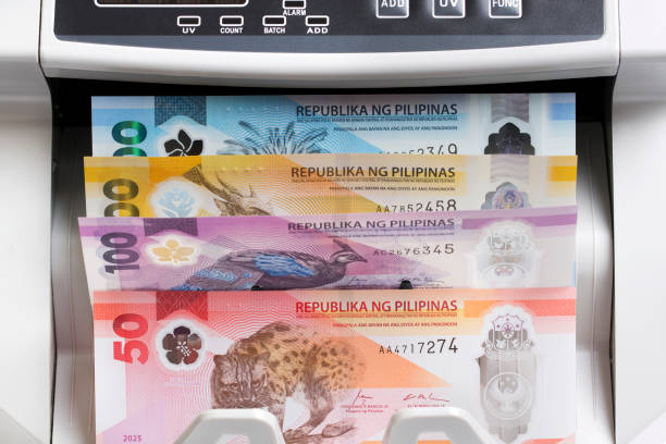 istock Philippine peso in the counting machine 2204493205
