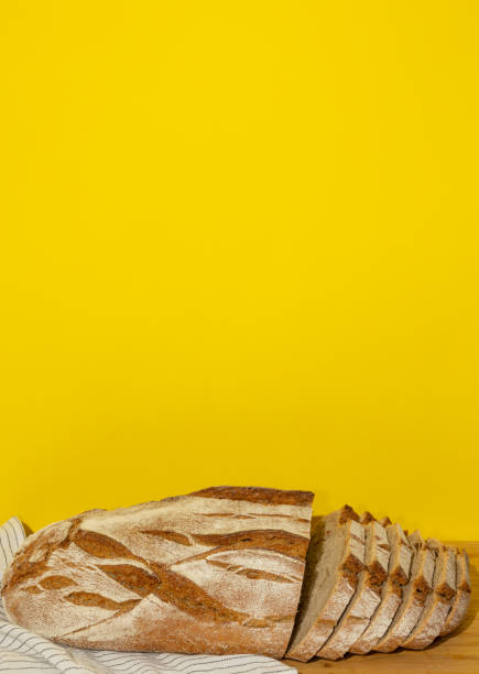 A freshly-made loaf of bread is sitting on a table inside a bakery.