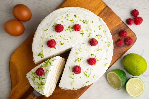 istock Crepe and cream cake decorated with lime and raspberries. 2204494211