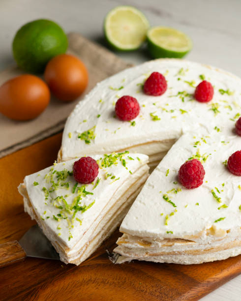 istock Crepe and cream cake decorated with lime and raspberries. 2204494218