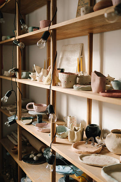 istock Creating ceramics ware with own hands. Shelf with handmade clay cups and plates in the pottery studio. 2204495018