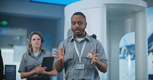 istock Security Officer Conducting Planning Session, Giving Instructions to Group of Workers 2204495182