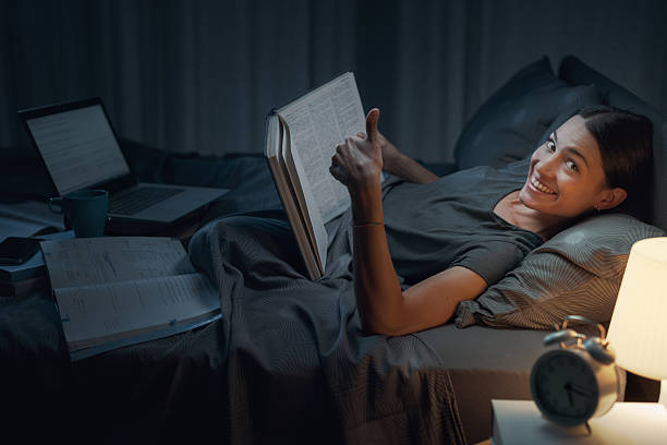 istock Happy woman studying the night before the exam 2204495348