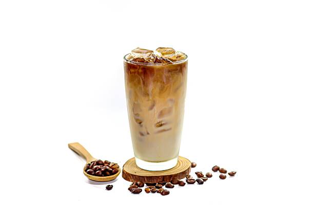 istock Latte ice coffee serving on coffee beans spread in white background and isolated photo style. 2204495618