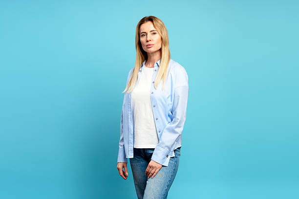 istock Confident businesswoman posing on blue background in studio 2204495722