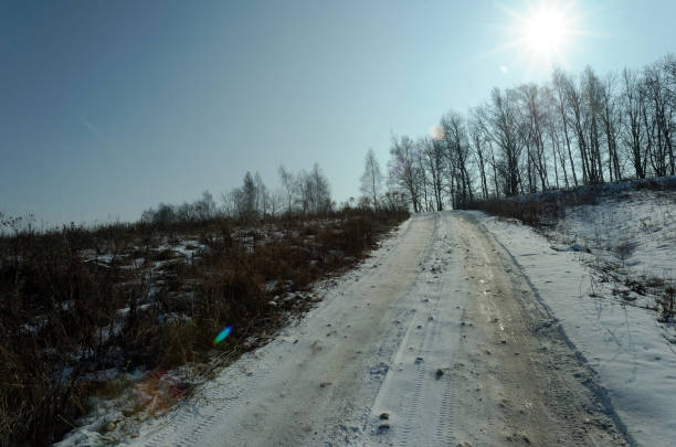Snow-covered dirt road on a clear day, Russia