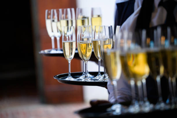istock Waiters Serving Champagne Glasses at a Formal Event Celebration Party 2204498916