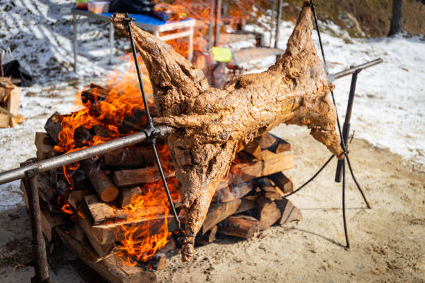 istock Whole lamb roasted on wood outside over an open fire on a holiday. 2204499027