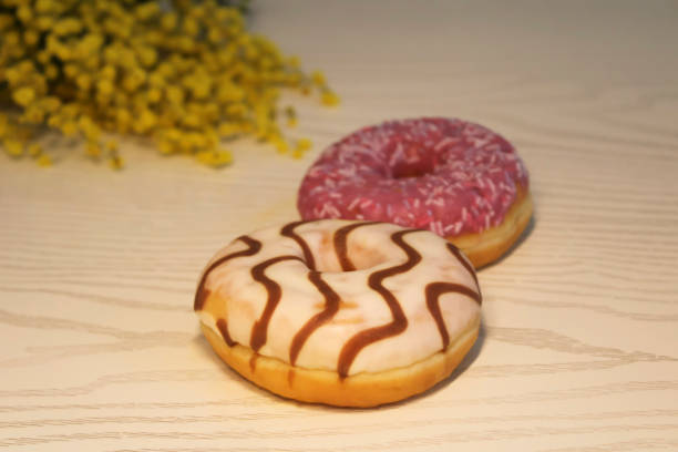 Two or a couple of frosted doughnuts.