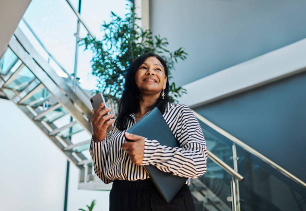 istock Confident Professional Woman Holding Phone and Folder 2204501272