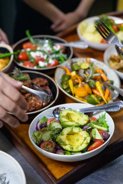 istock Assorted Freshly Prepared Healthy Dishes Including Avocado Salad and Vegetables 2204501573