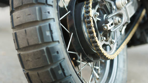 Close-up of muddy rear wheel and engine of dirt motorcycle details. Extreme sport competition.