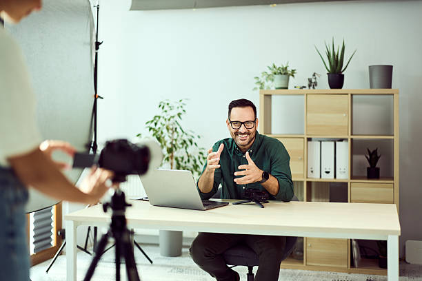 istock Person Recording Video Content in a Modern Office Environment with Digital Equipment 2204502856