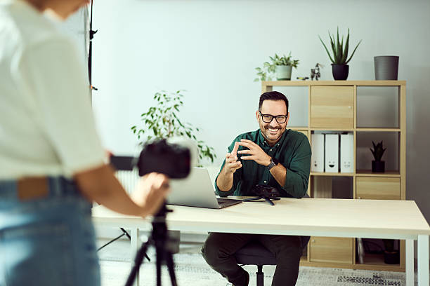 istock Man Recording Professional Video in Office with Camera and Microphone 2204502857