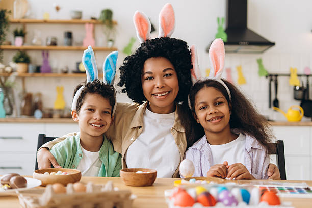 istock Happy Family Painting Easter Eggs Wearing Bunny Ears 2204502980