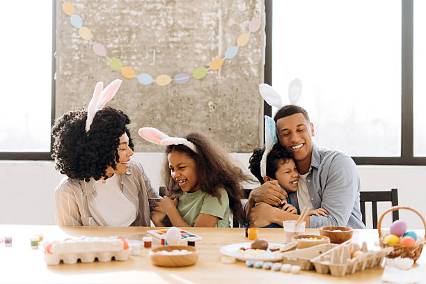 istock Happy Latin family painting easter eggs wearing bunny ears 2204502993
