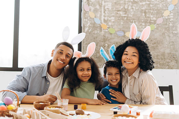 istock Happy family painting easter eggs wearing bunny ears 2204503006