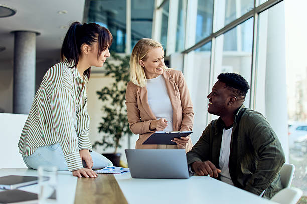 istock Young Professionals Collaborating in Modern Office With Natural Light 2204505411