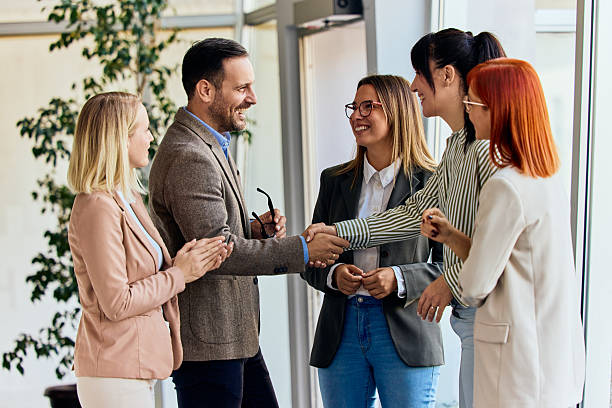 istock Professional Team Greeting Each Other Warmly in a Modern Office Environment 2204505427