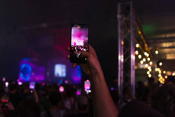 istock Person holding smartphone at concert 2204505763
