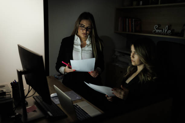 istock Focused Businesswomen Working Late in Office 2204506412