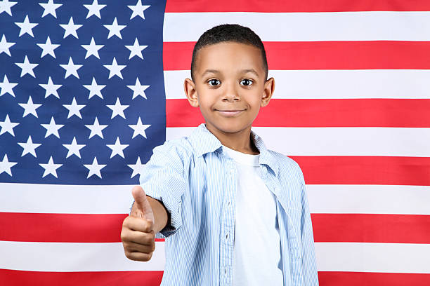 istock Cute boy showing thumb up on american flag background 2204506989