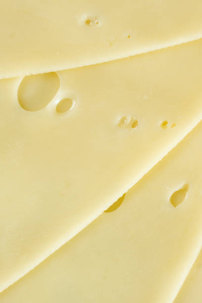 istock Semi-hard cheese close-up, thin slices, top view 2204509394