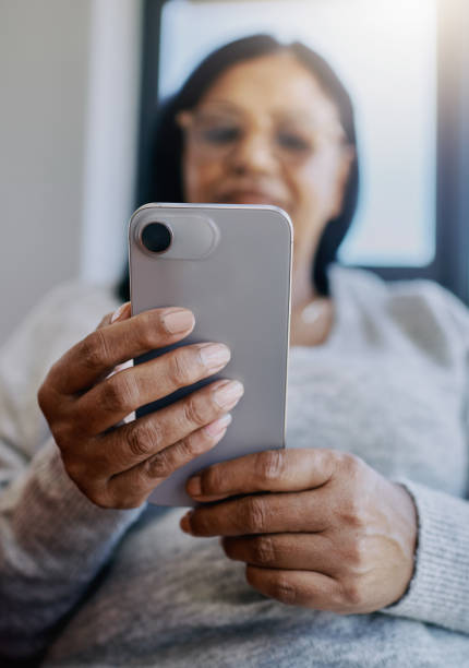 istock Close-up of African woman texting using mobile phone 2204512423