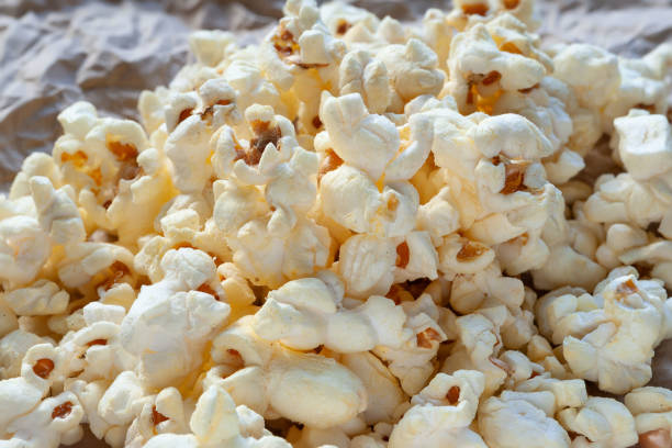 istock Popcorn. A pile of popcorn on the table 2204513475