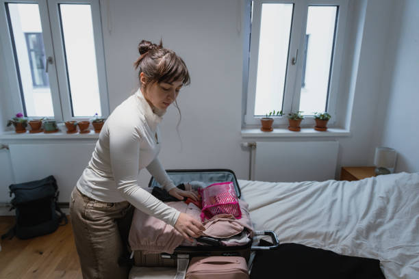 istock Young Woman Packing Suitcase for a Trip 2204513747