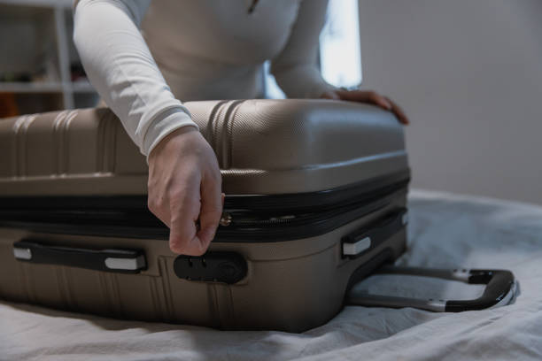 istock Closing a Packed Suitcase Before Travel - Preparing for road trip 2204514664