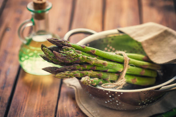 Preparing fresh asparagus with quail eggs