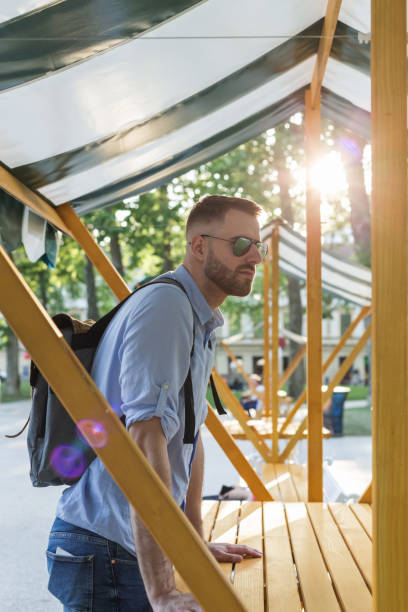 istock Young man tourist standing at the city square 2204515765