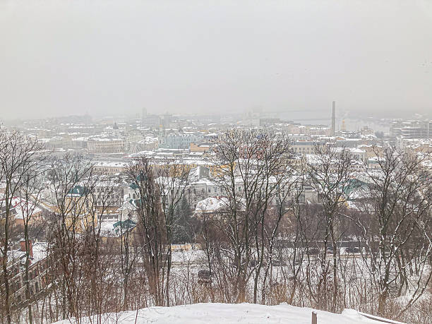 istock A wintry cityscape taken from an elevated vantage point, showing European architecture under a snowy blanket, likely late autumn or winter, with overcast sky and bare trees 2204516091