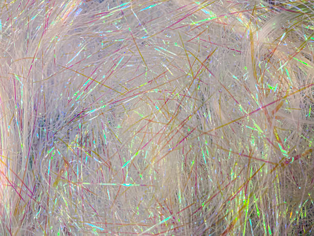 istock Close-up image of reflective, intertwined fibers displaying iridescent colors under different light conditions in an urban environment 2204516307