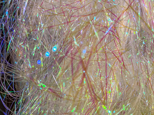 istock Close-up image of multi-colored, glittery particles densely packed on a surface, reflecting light and creating layers Particles could be glitter, sequins, confetti, or another decorative material N 2204516331